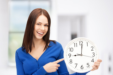 woman holding big clock