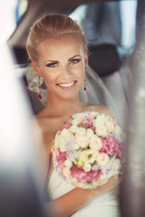 Beautiful bride in car at wedding day