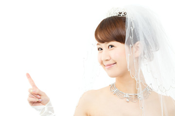 Beautiful asian woman dressed as a bride on white background