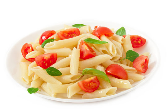 Pasta salad with cherry tomatoes and fresh basil leaves
