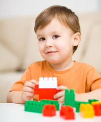 Boy is playing with building blocks