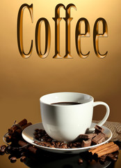 Cup of coffee and beans, cinnamon sticks and chocolate