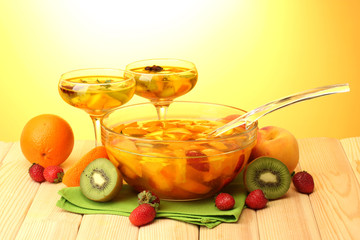 punch in bowl and glasses with fruits,