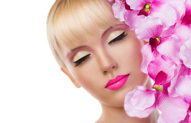 Obraz na płótnie Canvas Beautiful blonde girl with flowers and pink makeup