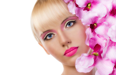 Beautiful blonde woman with flowers and pink makeup