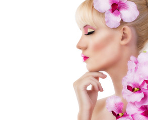 Beautiful woman with flowers and pink makeup