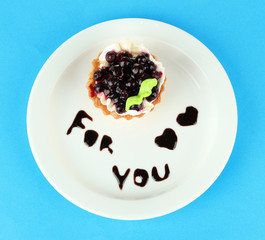 Sweet cake with blackberry and chocolate sauce