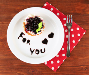 Sweet cake with blackberry and chocolate sauce