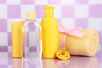 Obraz na płótnie Canvas Baby cosmetics and towel in bathroom
