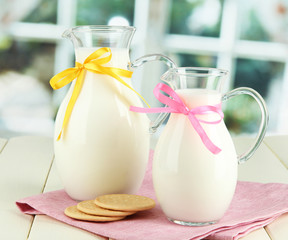 Pitchers of milk on table in room