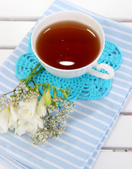 Beautiful composition with cup of tea and flowers