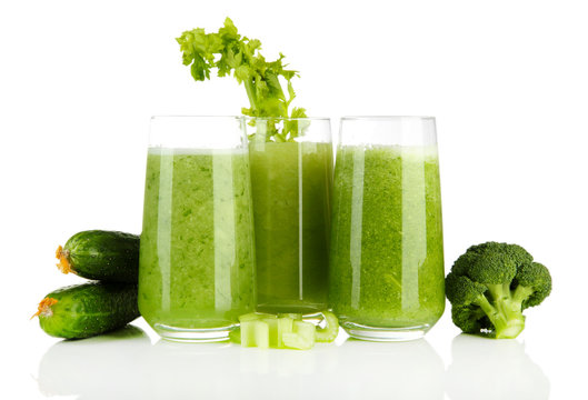 Glasses of green vegetable juice, isolated on white