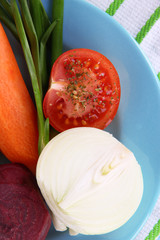 Peeled vegetables on plate on napkin close-up