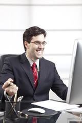 happy businessman in front of the computer.