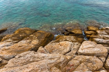 Shore of an ocean with big rocks