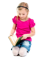 Small and beautiful girl reading a book