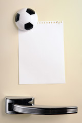 Blank note with football magnet on fifties fridge door