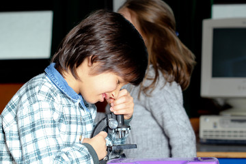 Fototapeta na wymiar Children in classroom - work with microscope
