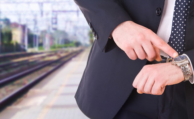 Businessman pointing at his wristwatch.