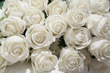 Bunch of artificial white roses with selective focus