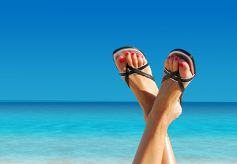 feet crossed on an island paradise