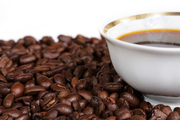 Coffee cup and grain on white background