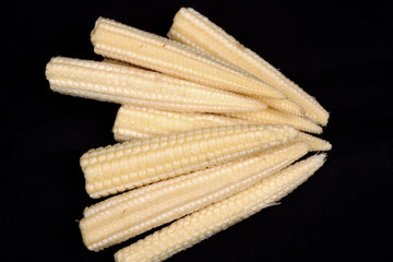 Baby corn on black background