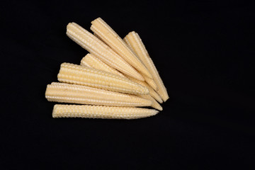 Baby corn on black background