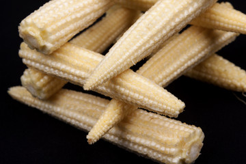 Baby corn on black background