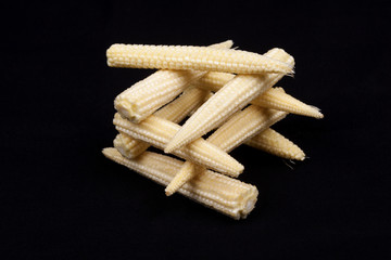 Baby corn on black background