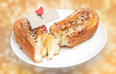 delicious breads with sesame and card bank paper and hearts on t