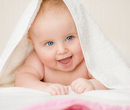happy baby with towel