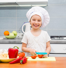 little girl cutting tomatoes