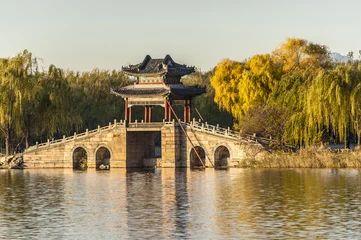 Fototapeten Willow bridge at Xidi of Summer Palace in autumn, Beijing © axz65