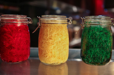 Jars of coloured pasta