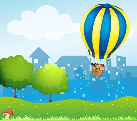Fotobehang Sprookjeswereld Een grote heteluchtballon boven de heuvel