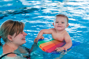 Little baby with blue eyes learning to swim © Irina Schmidt