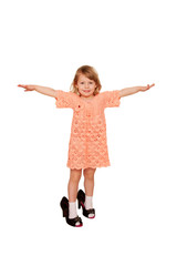 Happy little girl wearing her mother's shoes and jewelry