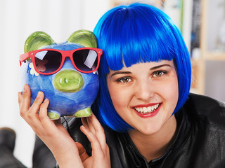 teenager girl with piggy bank