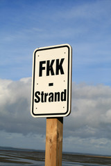 FKK-Schild am Suedstrand von Wyk auf Foehr mit bedecktem Himmel.
