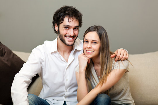 Portrait of a lovely young couple sitting on the couch
