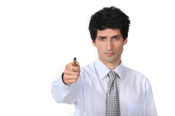 man in a suit holding a pen