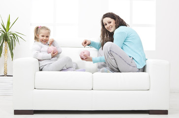 Mother and Daughter on sofa learn about savings