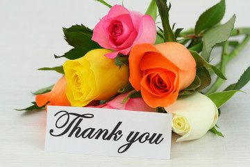 Thank you note and colorful bouquet of roses