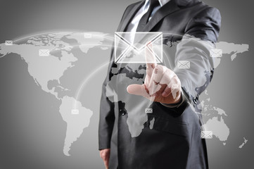 businessman pushing mail on world map 