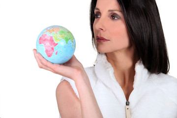 Woman holding small globe