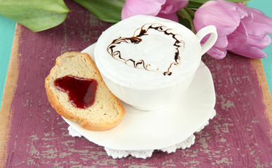Composition of coffee, toast and tulips on color background