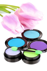 Bright eye shadows and sponge brushes for foundation close up