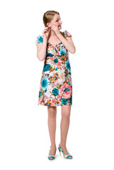 Beautiful girl in full growth in a flowered dress.