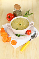 Nourishing soup in pink pan with ingredients